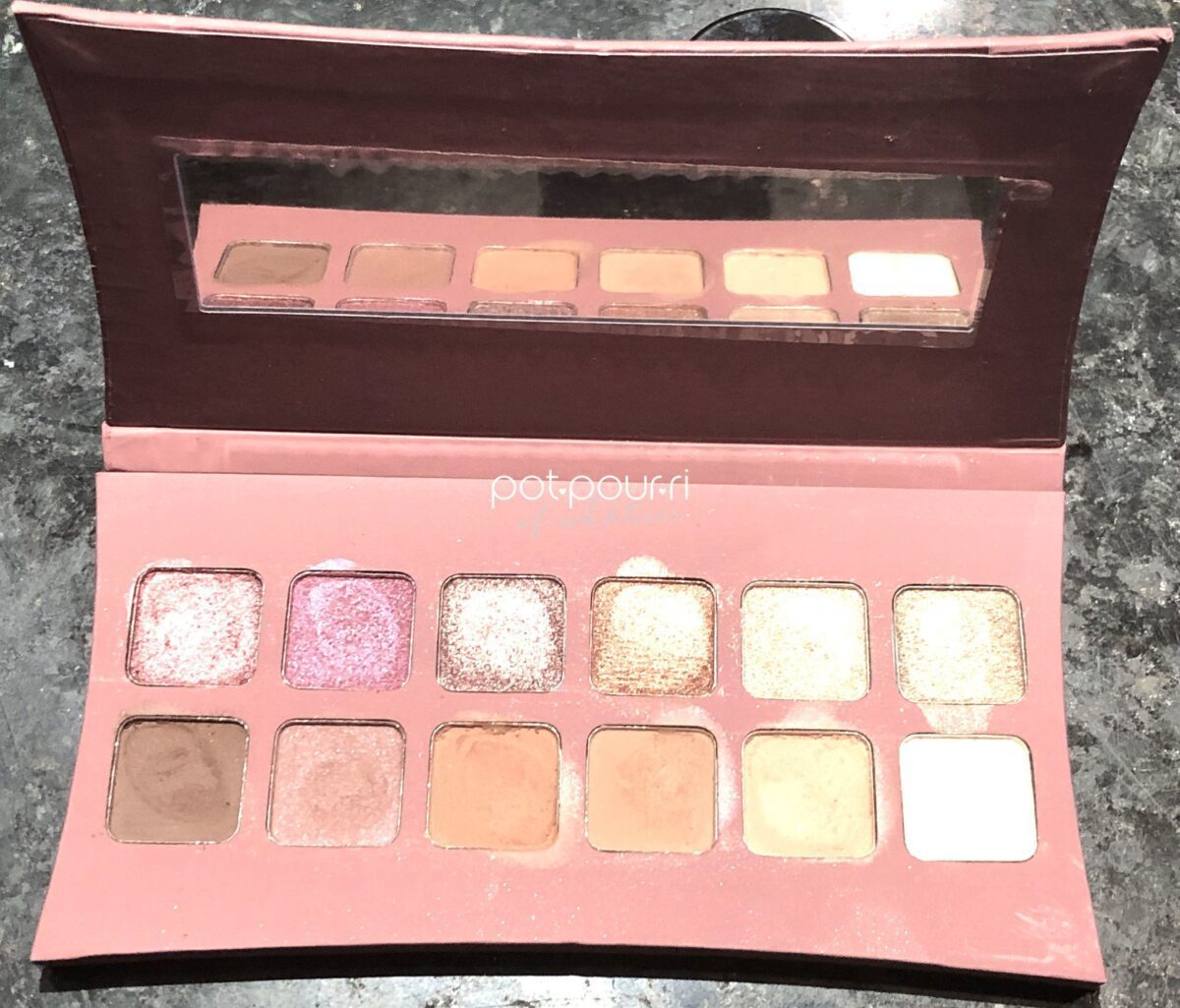 INSIDE THE UNVEILED ARTISTRY PALETTE ARE 6 METALLIC SHADES ACROSS THE TOP ROW,, AND 6 MATTE SHADES ACROSS THE BOTTOM ROW, AND A RECTANGULAR MIRROR
