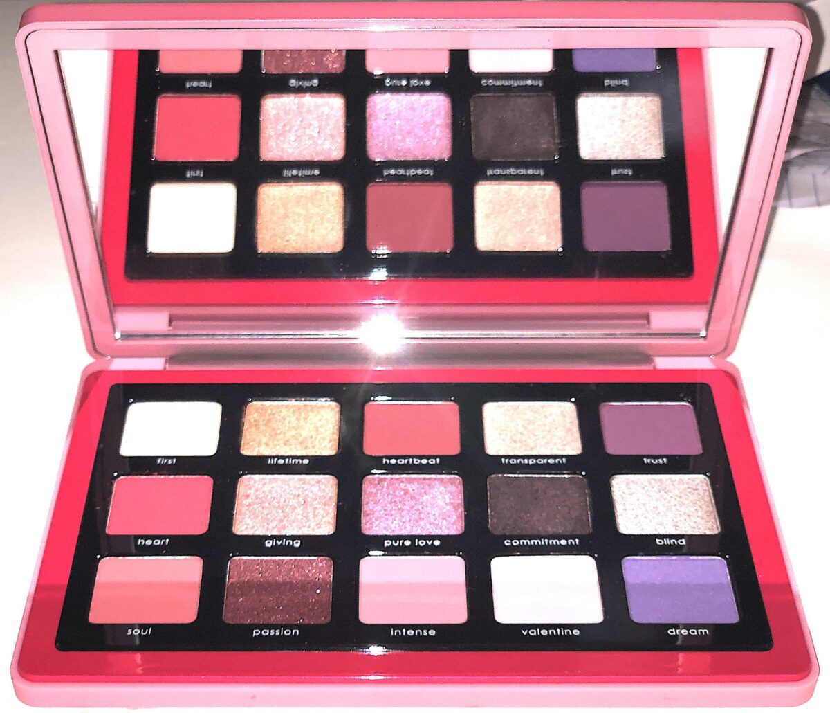 INSIDE THE LOVE PALETTE IS A HUGE MIRROR AND 15 EYESHADOW PANS