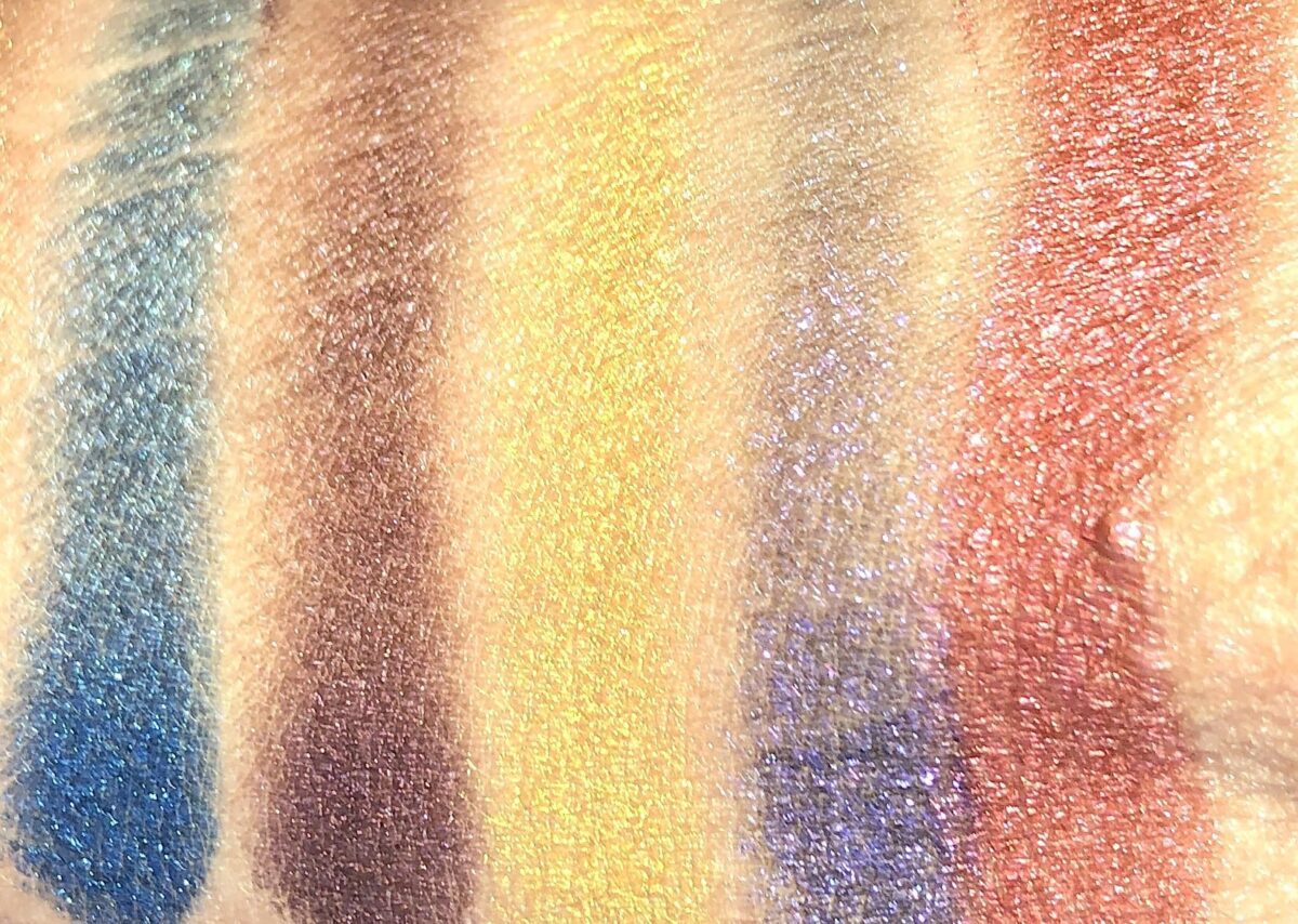 SWATCHES FROM LEFT TO RIGHT ARE LAPIS LUXURY, BLUE BLOOD, GOLD STANDARD, SYNTHETICA, AND CRIMSON FIRE