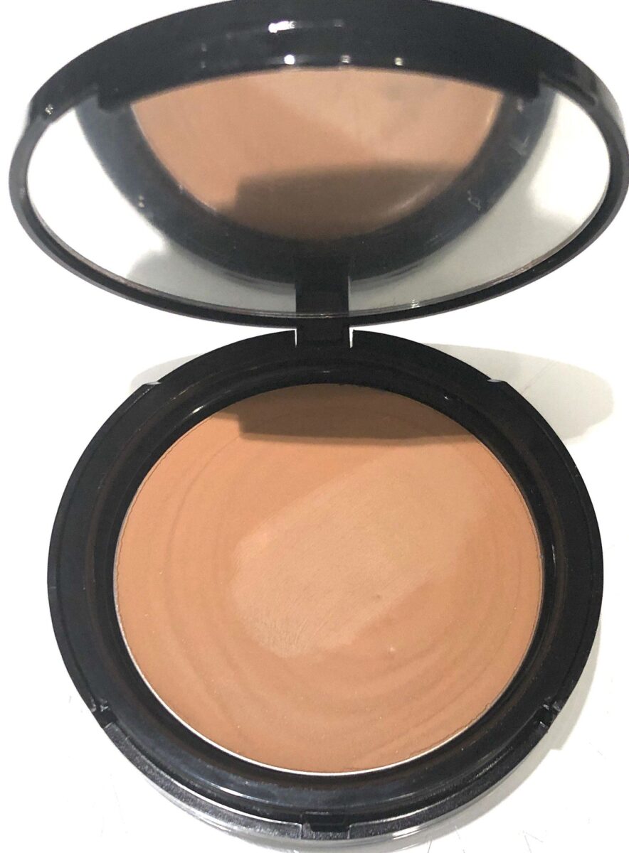 VOODOO MAKEUP COCONUT CREAM FOUNDATION POWDER OPENED COMPACT HAS TANNED BEAUTY FOUNDATION AND A FULL-SIZED MIRROR, AND IS MADE WITH STURY PLASTIC
